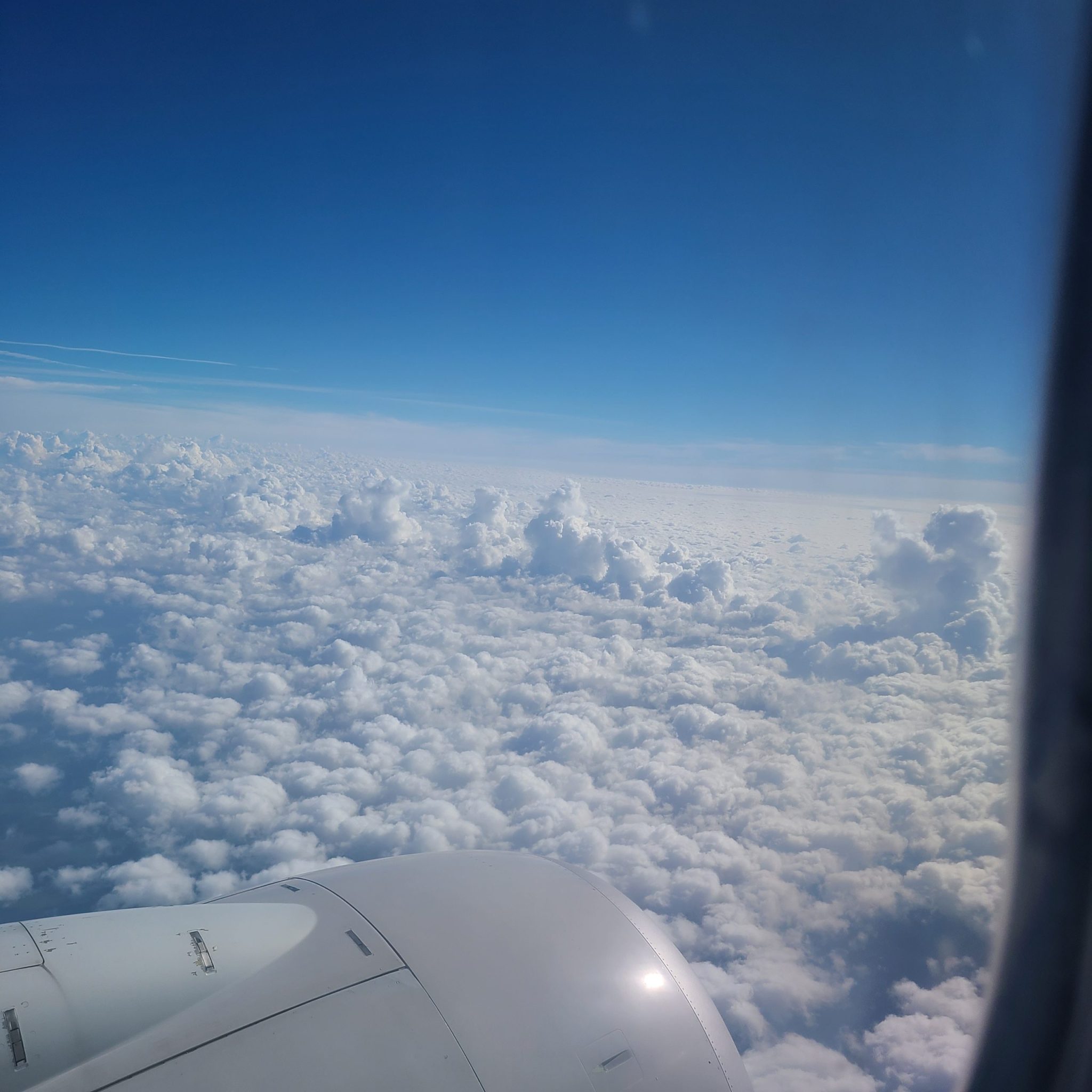 Airplane view of fluffy clouds above Cancun, Mexico