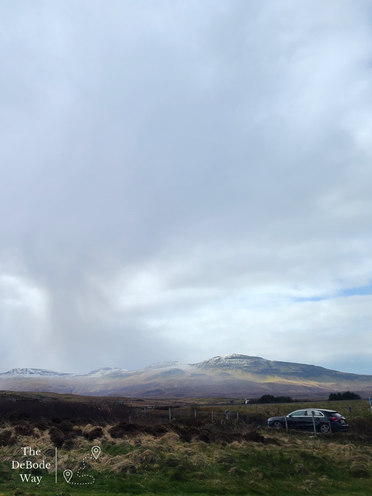 Lone black car in a colorful Isle of Skye landscape on our DIY trip