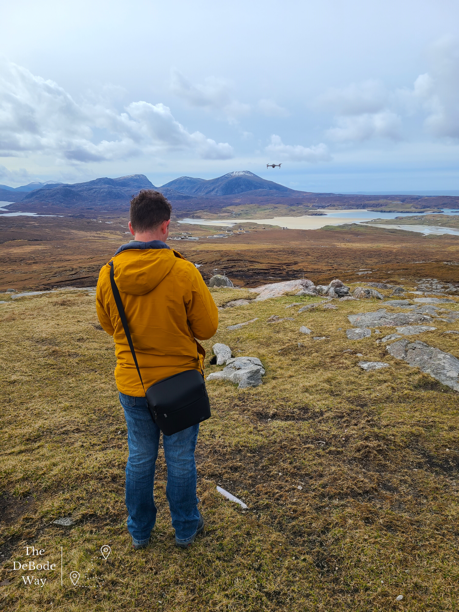 Jason flying his drone from the top of a hill surrounded by mountains, moors and beaches