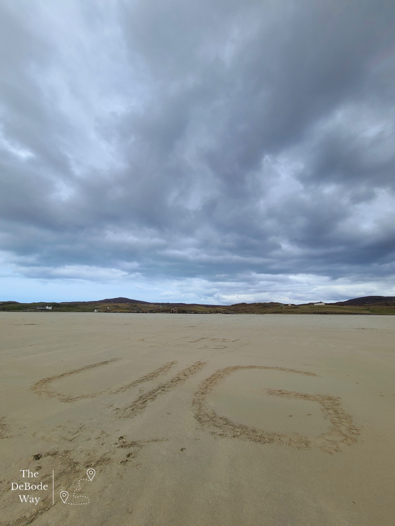 Vast flat sandy beach with moody clouds above