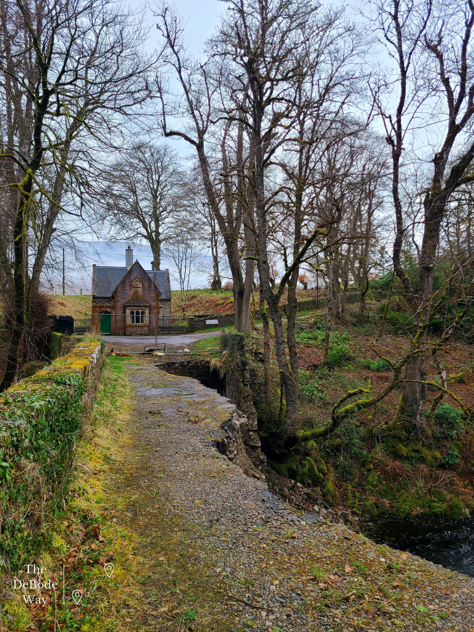 Washed out stone bridge over the river to a gate house