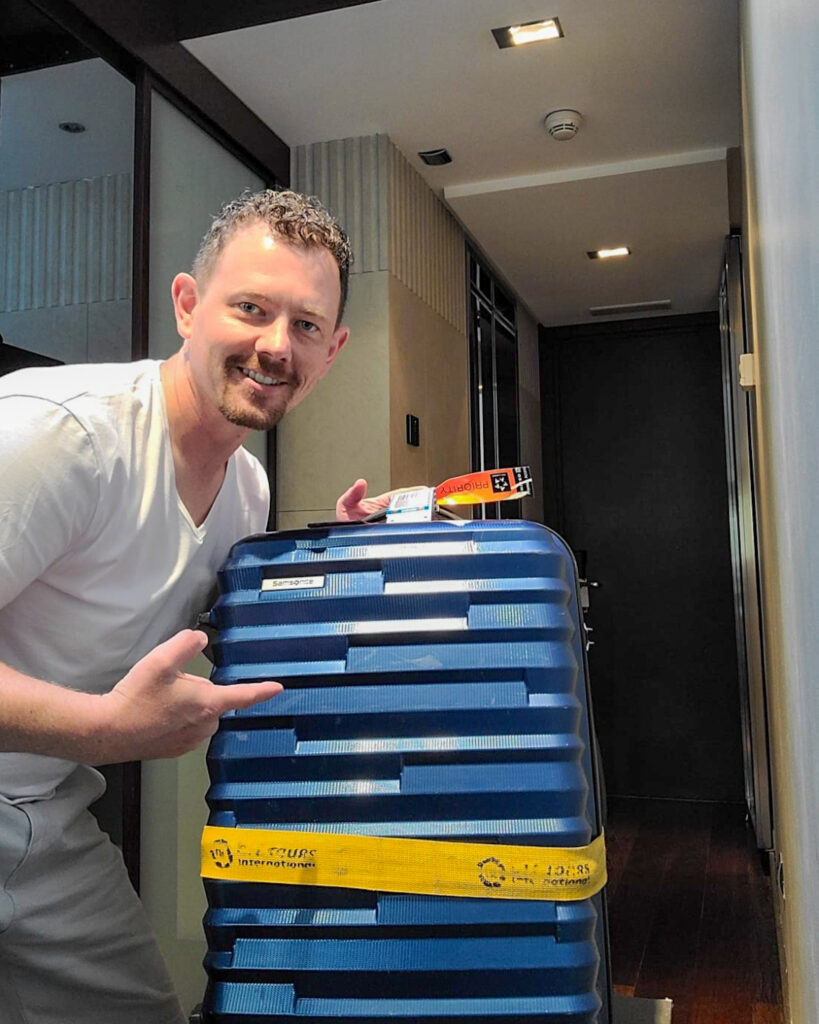 Jason with his lost luggage that finally arrived at his hotel
