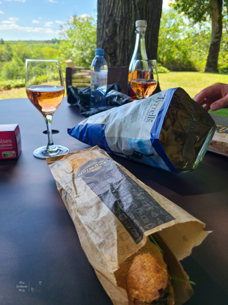 Sandwich, chips, and rose lunch under the trees