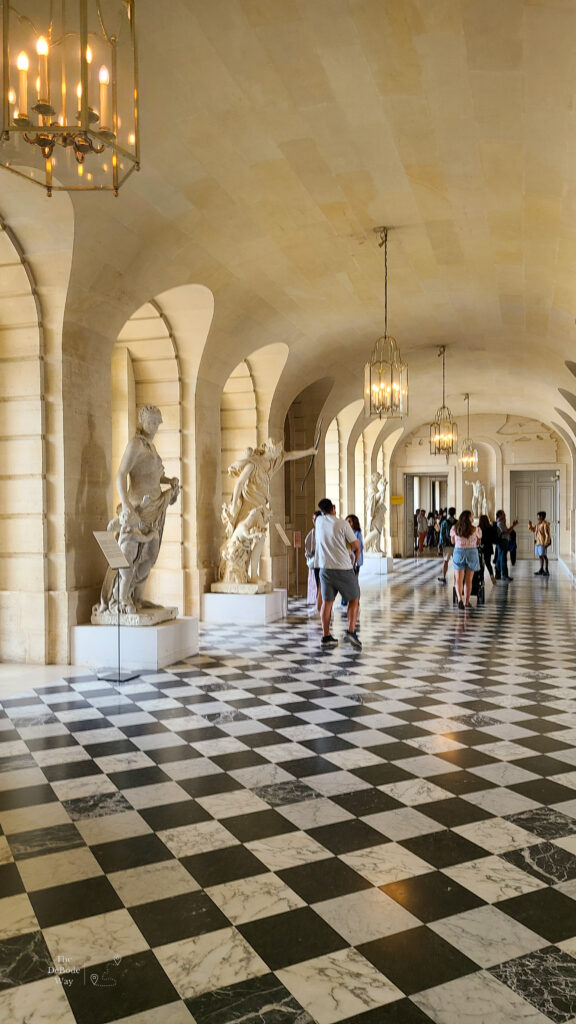 Statue Gallery with black and white checkered marble floor at the Palace of Versailles