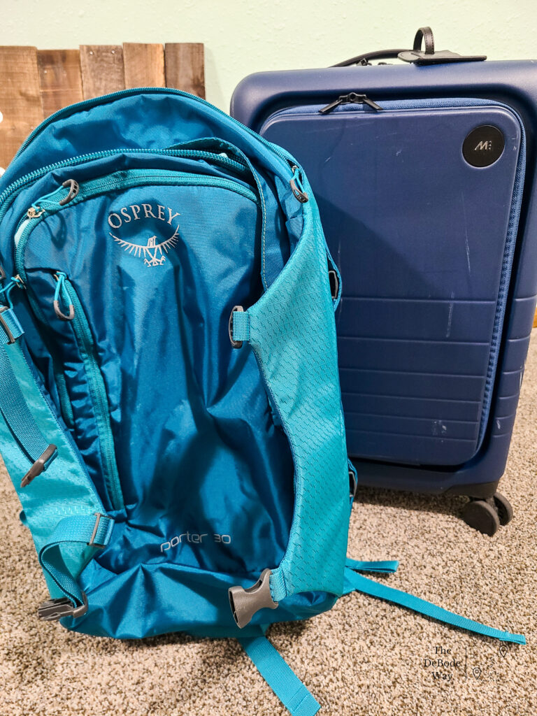 My trusty teal Osprey backpack and my new, roughed up, blue Monos luggage to pack for with our international travel packing list