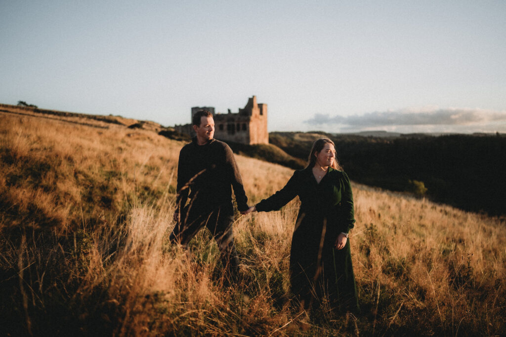 Jason and Tasha in the Scottish Borders on a mountain near a castle ruin