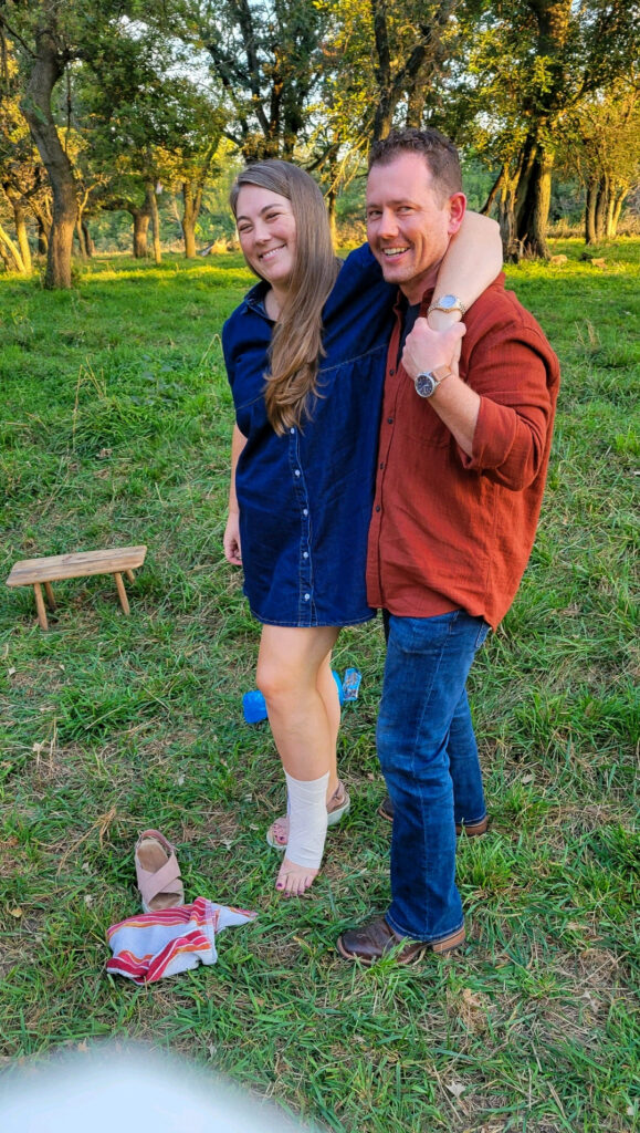 Jason holding Tasha up to walk in the pasture with her foot wrapped
