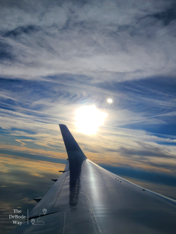 Sunrise over a plane wing over the Atlantic Ocean