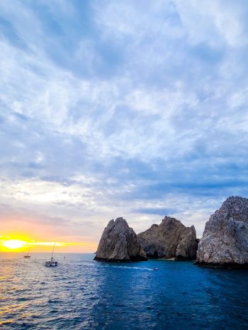 Sunset over the rocks and water in Cabo, Mexico - Holiday Travel Inspiration