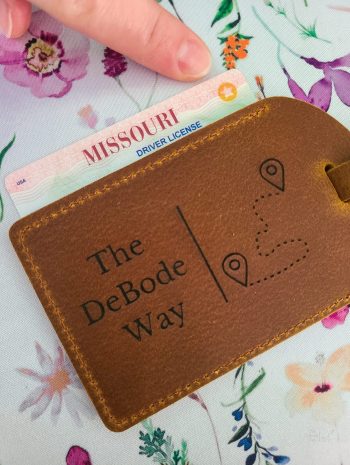 Missouri REAL ID under a brown leather luggage day with The DeBode Way logo